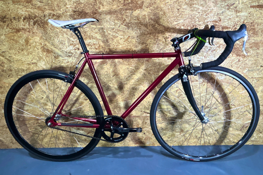 Red bicycle on a wooden floor